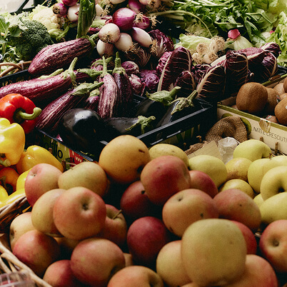 Crates of fresh fruit and vegetables at a market stall