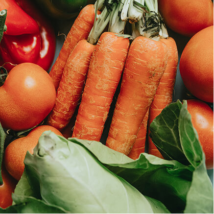 Carrots, tomatoes, peppers and cabbage leaves packed together