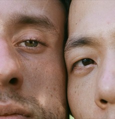 Two faces side by side, close-cropped in daylight